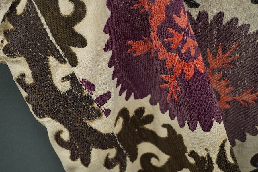 A late 19th early 20th century Uzbekistan (possibly Samarkand) embroidered Suzani. Made from hand loomed linen, pieced together then hand embroidered with large decorative sun or moon motifs as a large table cover or han